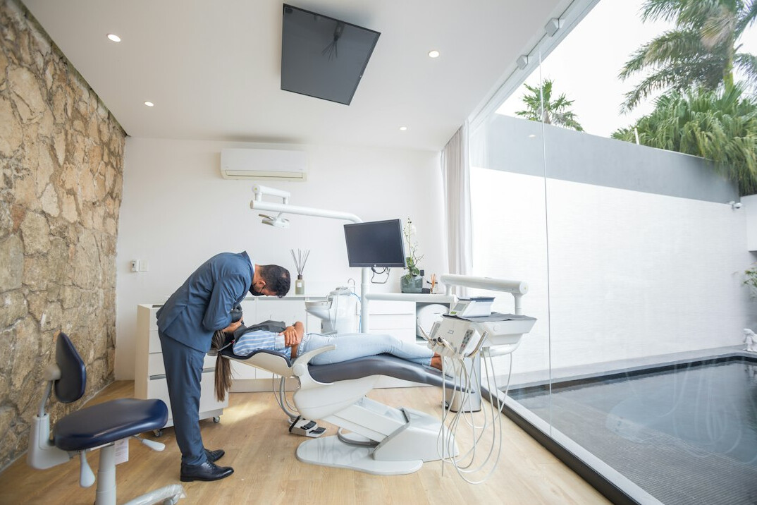 Ergonomics specialist adjusting an office chair for an employee
